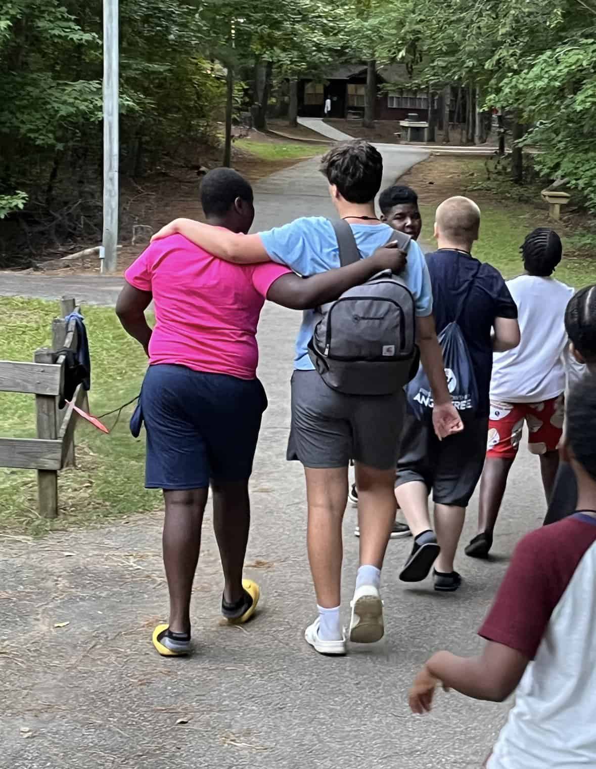 Young diverse group of children walking together outdoors, promoting leadership and community engage.